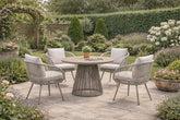 Luxury 4 seater natural rattan garden dining set with round wood-effect table and comfortable cushioned chairs on a modern patio.