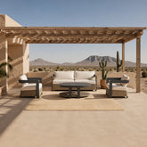Luxury 5 seater wicker and aluminium garden lounge set with premium grey cushions and sintered stone coffee table on a modern outdoor patio.