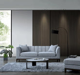Luxury Cooper 3 Seater Sofa upholstered in dolphin grey bouclé fabric with deep cushions, wooden plinth base, and a modern mid-century silhouette for stylish UK homes.