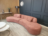 Luxury Miami curved 6-seater bouclé sofa with sculptural organic silhouette, deep cushioned seating.