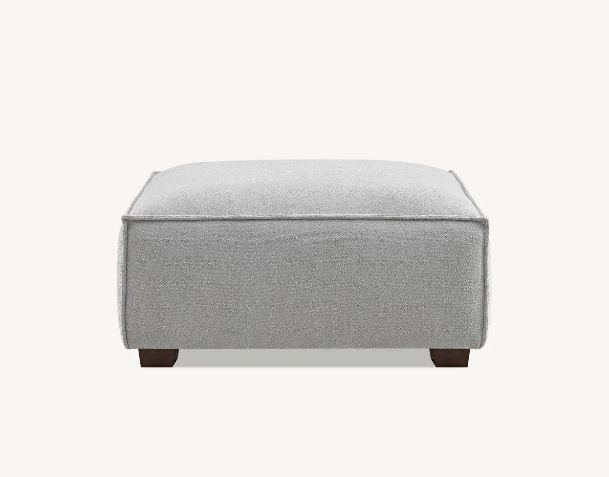 Modern charcoal bouclé chaise sofa with elegant piping and walnut feet.