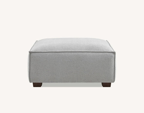 Modern charcoal bouclé chaise sofa with elegant piping and walnut feet.