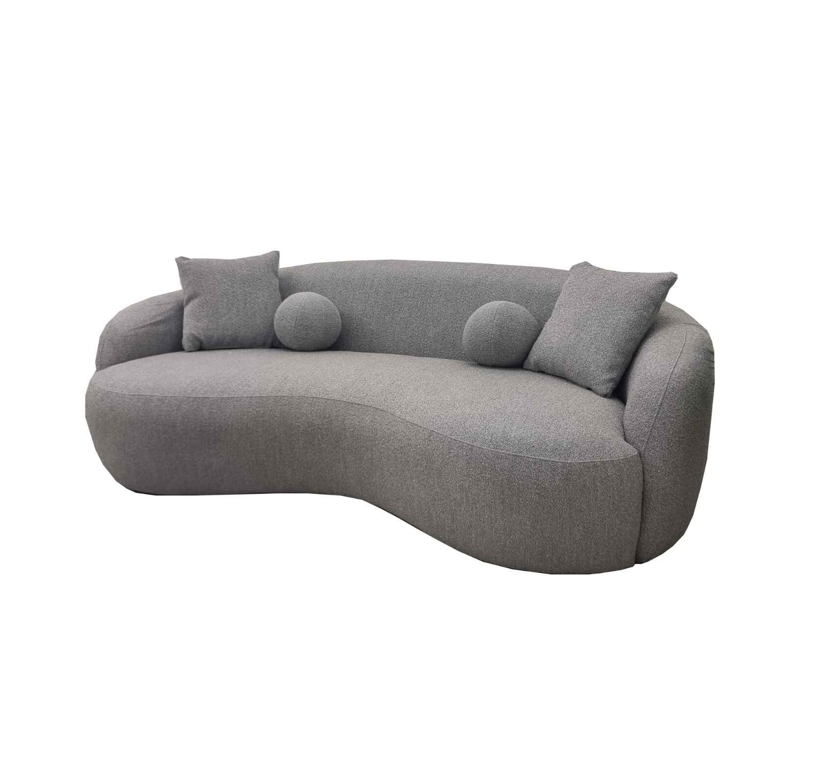 Luxury Wave bouclé sofa with a sculptural curved silhouette, premium textured upholstery, deep foam cushions, and modern designer styling in a contemporary UK living room.