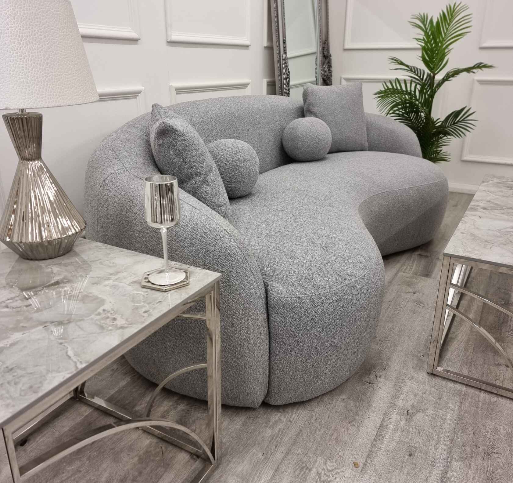 grey Wave bouclé sofa with a sculptural curved silhouette, premium textured upholstery, deep foam cushions, and modern designer styling in a contemporary UK living room.