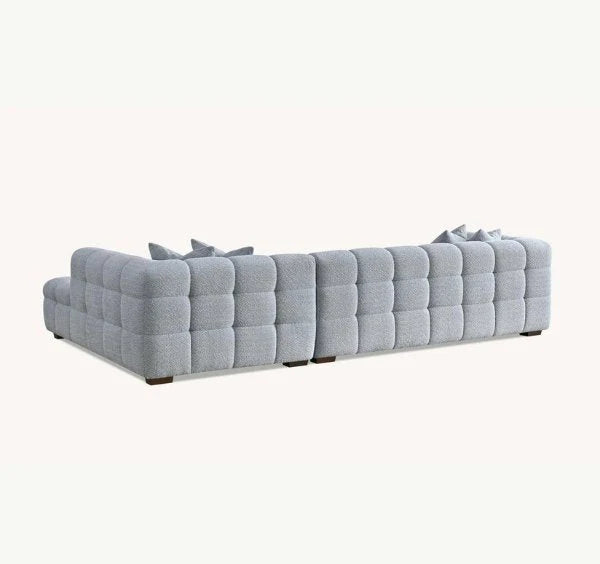 Luxury Tribeca pearl bouclé corner sofa with sculptural curved arms, deep channel stitching, premium textured and spacious L-shaped seating for modern UK living rooms.