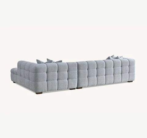 Luxury Tribeca pearl bouclé corner sofa with sculptural curved arms, deep channel stitching, premium textured and spacious L-shaped seating for modern UK living rooms.