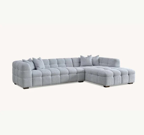Tribeca pearl bouclé corner sofa with sculptural curved arms, deep channel stitching, premium textured upholstery, and spacious L-shaped seating for modern UK living rooms.