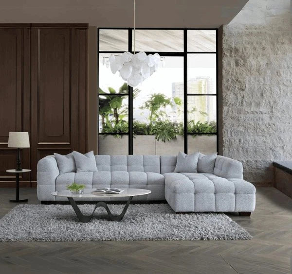 Luxury Tribeca pearl bouclé corner sofa with sculptural curved arms, deep channel stitching, premium textured upholstery, and spacious L-shaped seating for modern UK living rooms.