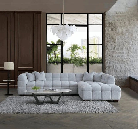 Luxury Tribeca pearl bouclé corner sofa with sculptural curved arms, deep channel stitching, premium textured upholstery, and spacious L-shaped seating for modern UK living rooms.