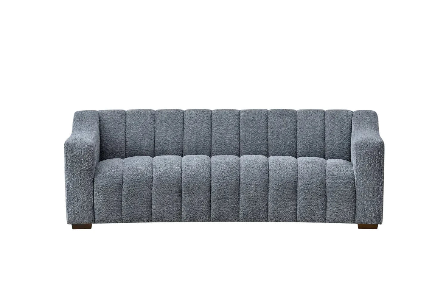 bouclé sofa with deep channel tufting, curved arms and premium textured upholstery in a modern UK living room.