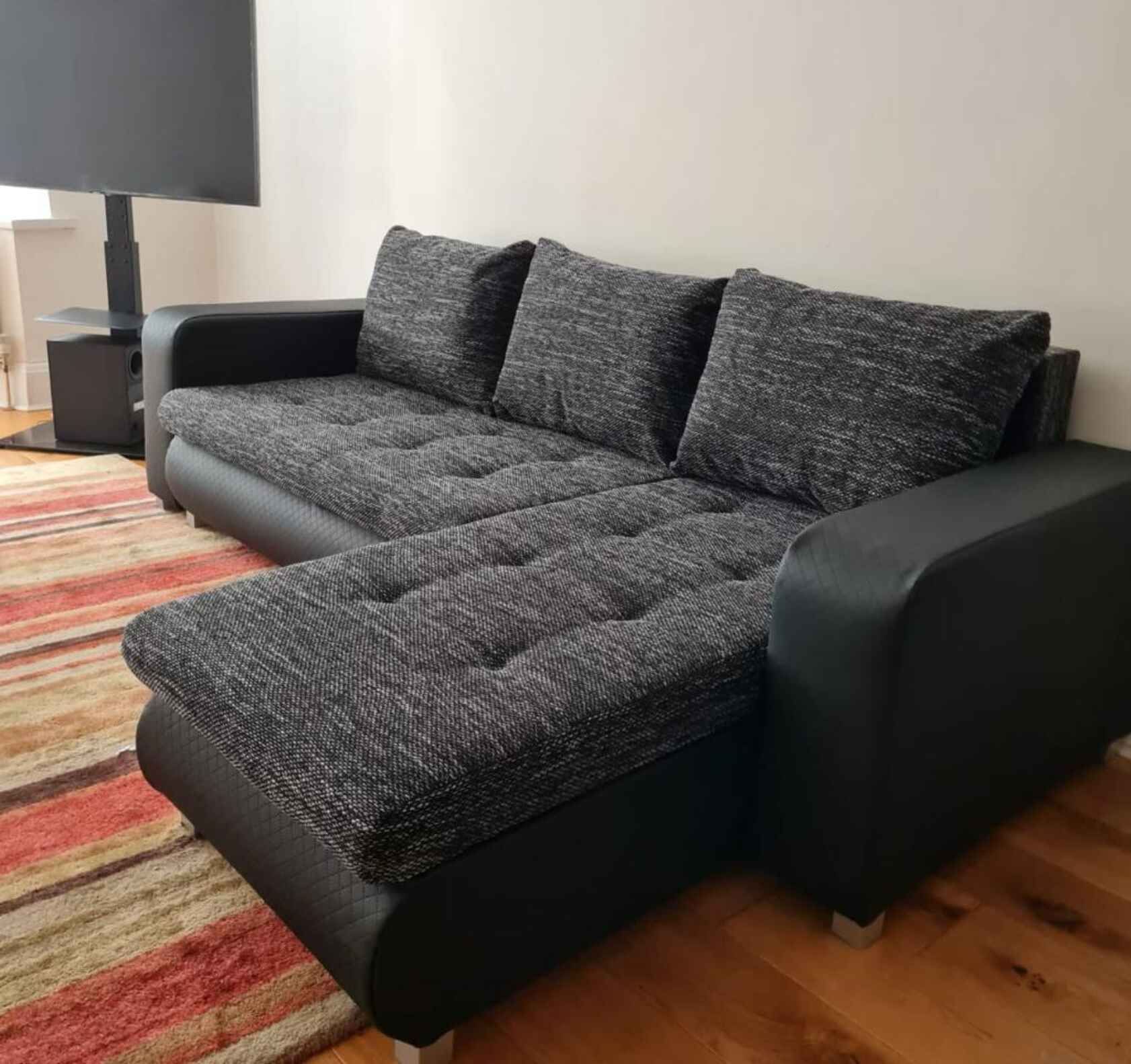 Berlin fabric corner sofa bed with hidden storage compartments, pull-out sleeping function, universal left or right-hand configuration, and contemporary styling for modern UK homes.