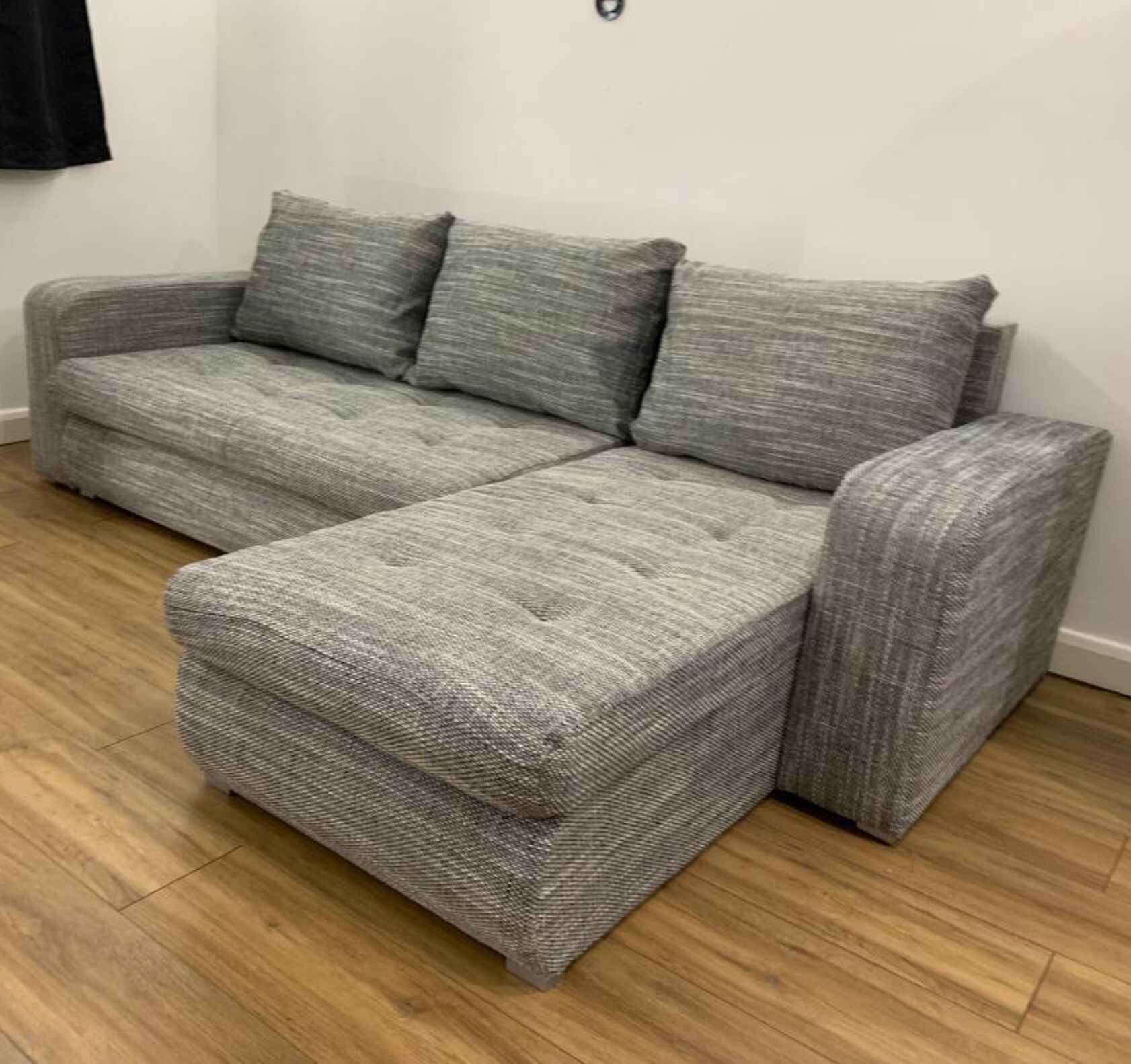 Luxury Berlin fabric corner sofa bed with hidden storage compartments, pull-out sleeping function, universal left or right-hand configuration, and contemporary styling for modern UK homes.