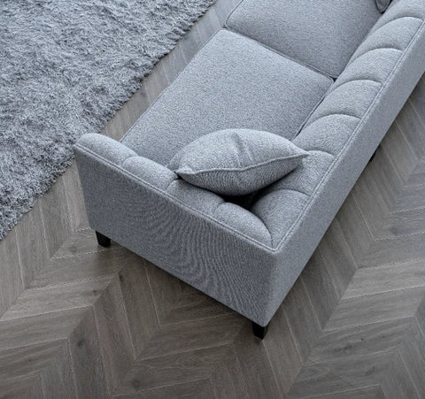 Cooper 3 Seater Sofa upholstered in dolphin grey bouclé fabric with deep cushions, wooden plinth base, and a modern mid-century silhouette for stylish UK homes.
