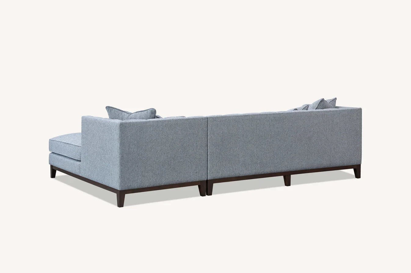  Dolphin Luxury Cooper grey bouclé corner sofa with spacious L-shaped seating, premium textured upholstery, solid wooden plinth base, and modern mid-century styling for UK homes.