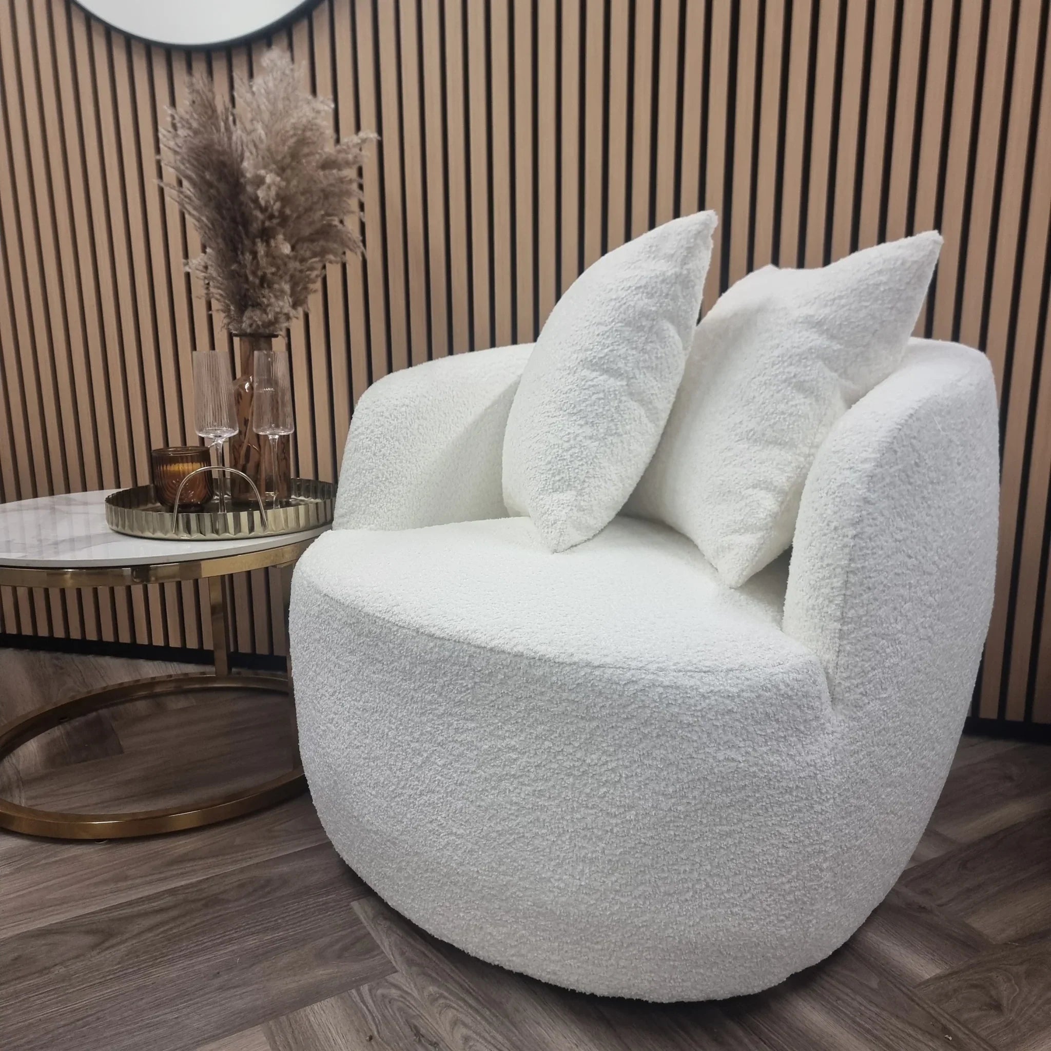 Cuddle bouclé accent chair with curved arms and soft textured upholstery.