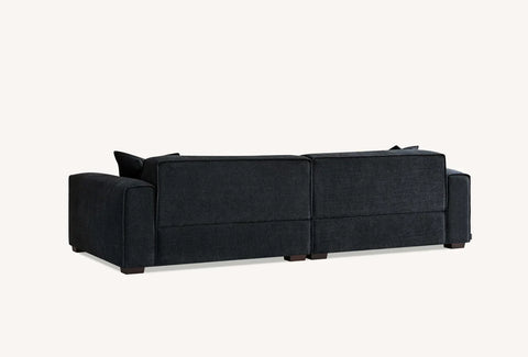 Luxury UK chaise sofa upholstered in soft charcoal bouclé fabric.