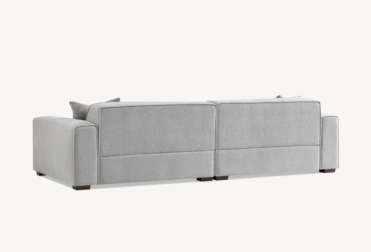 Spacious four seater charcoal sofa with chaise and contemporary minimalist design.