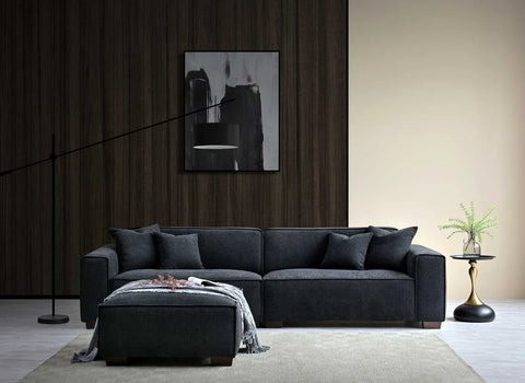 Contemporary charcoal bouclé sofa with chaise and deep feather-filled cushions.