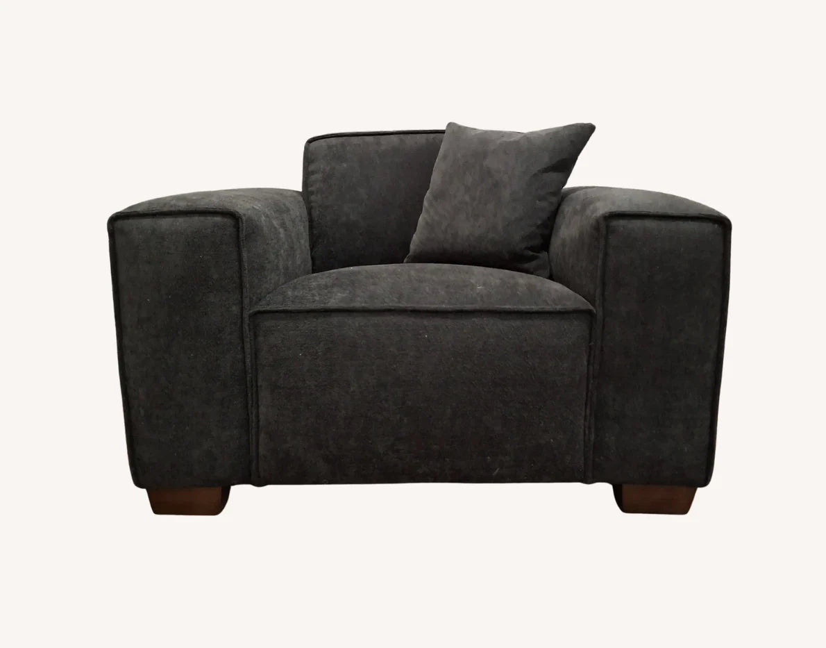 Elegant modern living room sofa in charcoal bouclé with feather-filled cushions.