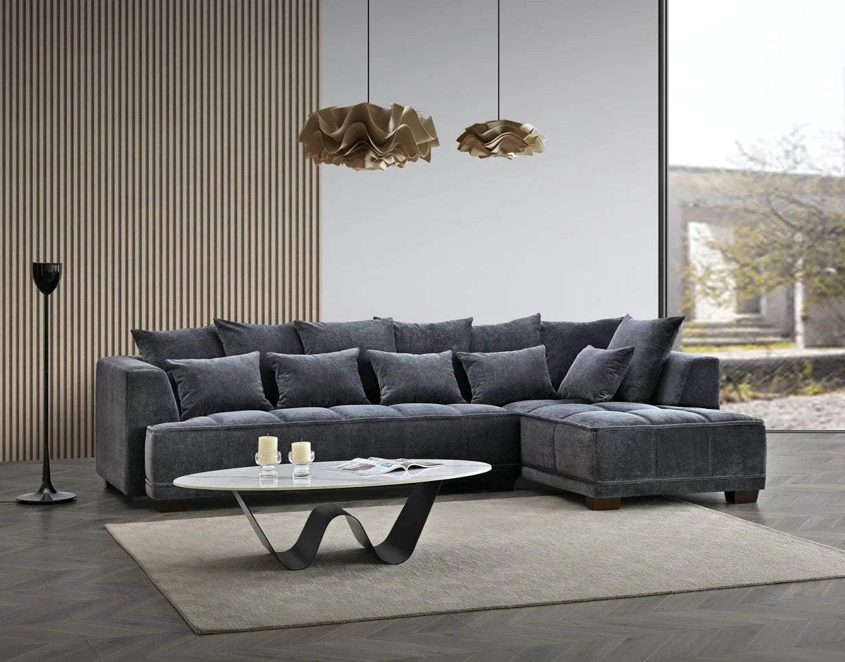 steel grey velvet corner sofa with deep block-stitched cushions, spacious L-shaped design, and premium upholstery in a modern UK living room.