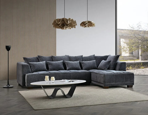steel grey velvet corner sofa with deep block-stitched cushions, spacious L-shaped design, and premium upholstery in a modern UK living room.