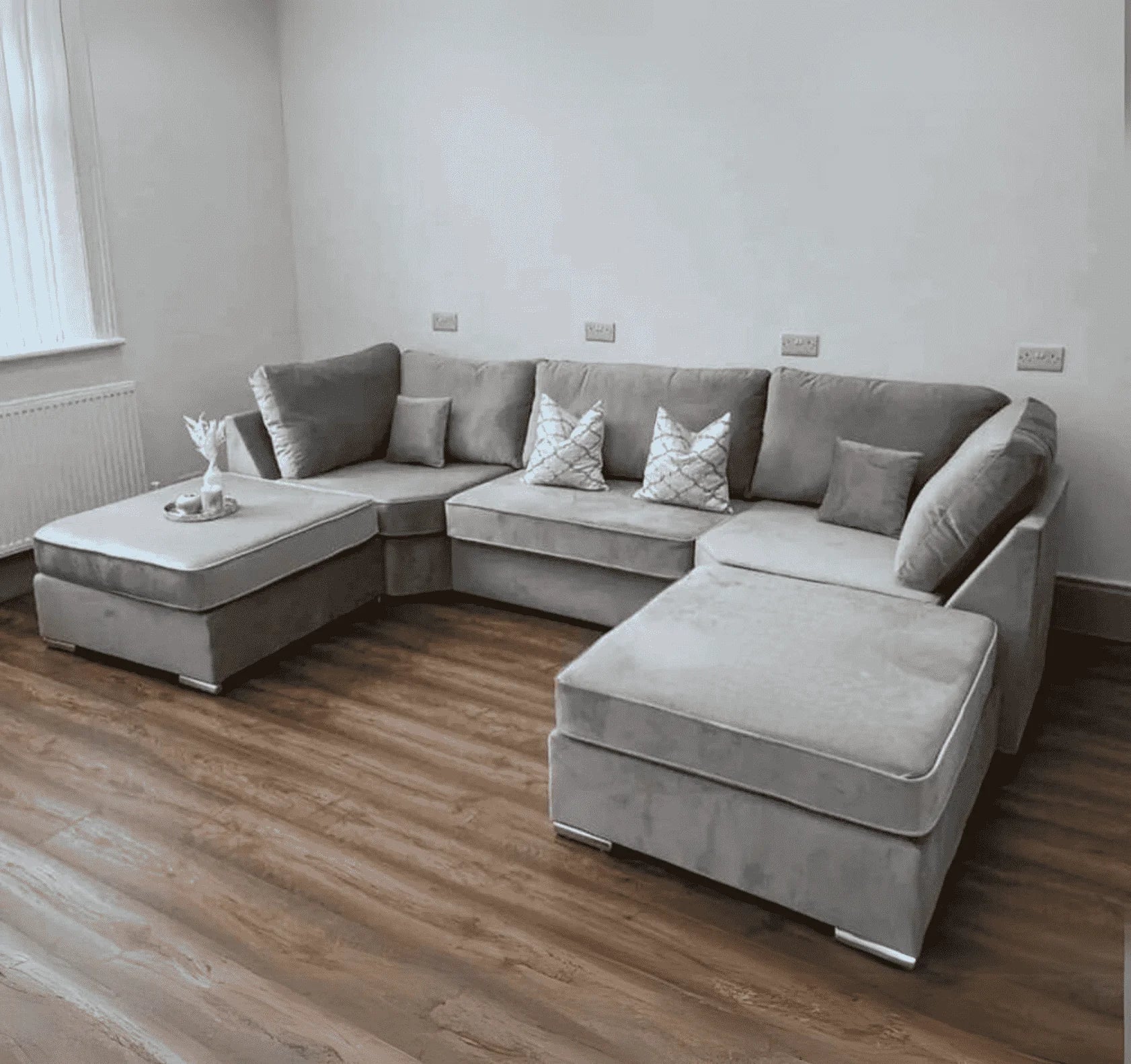 Luxury large U shape corner sofa with deep foam seating, movable footstools, removable washable covers, and contemporary styling for spacious UK living rooms.
