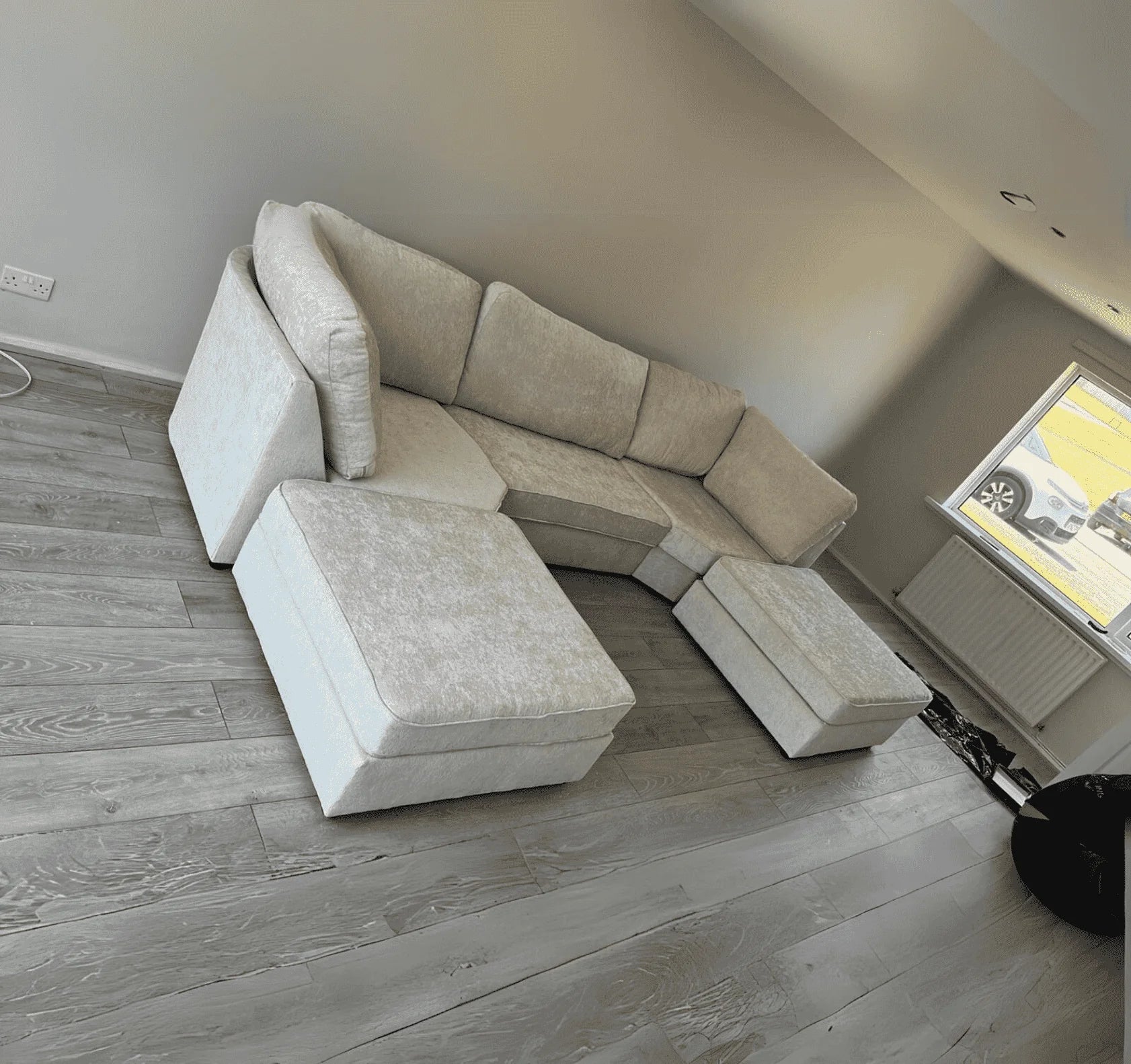 Luxury corner sofa with deep foam seating, movable footstools, removable washable covers, and contemporary styling for spacious UK living rooms.
