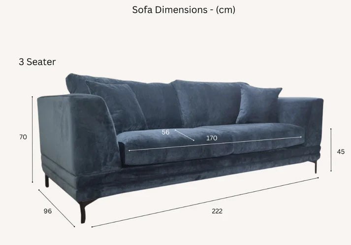 Luxury steel grey velvet sofa with a mid-century modern design, wooden plinth base, deep cushions, and elegant clean lines for contemporary UK living rooms.
