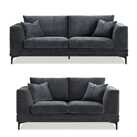 Luxury steel grey velvet sofa with a mid-century modern design, wooden plinth base, deep cushions, and elegant clean lines for contemporary UK living rooms.