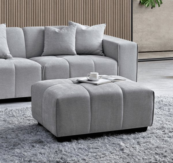 Luxury Leonard modular corner sofa upholstered in cloudy grey bouclé fabric featuring block-stitched cushions, spacious L-shaped seating, and contemporary styling for modern UK homes.