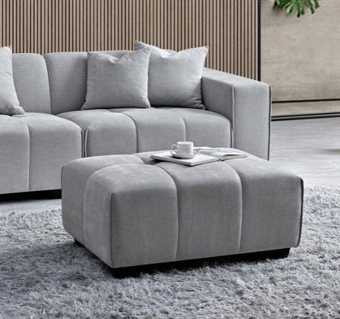 Luxury Leonard modular corner sofa upholstered in cloudy grey bouclé fabric featuring block-stitched cushions, spacious L-shaped seating, and contemporary styling for modern UK homes.