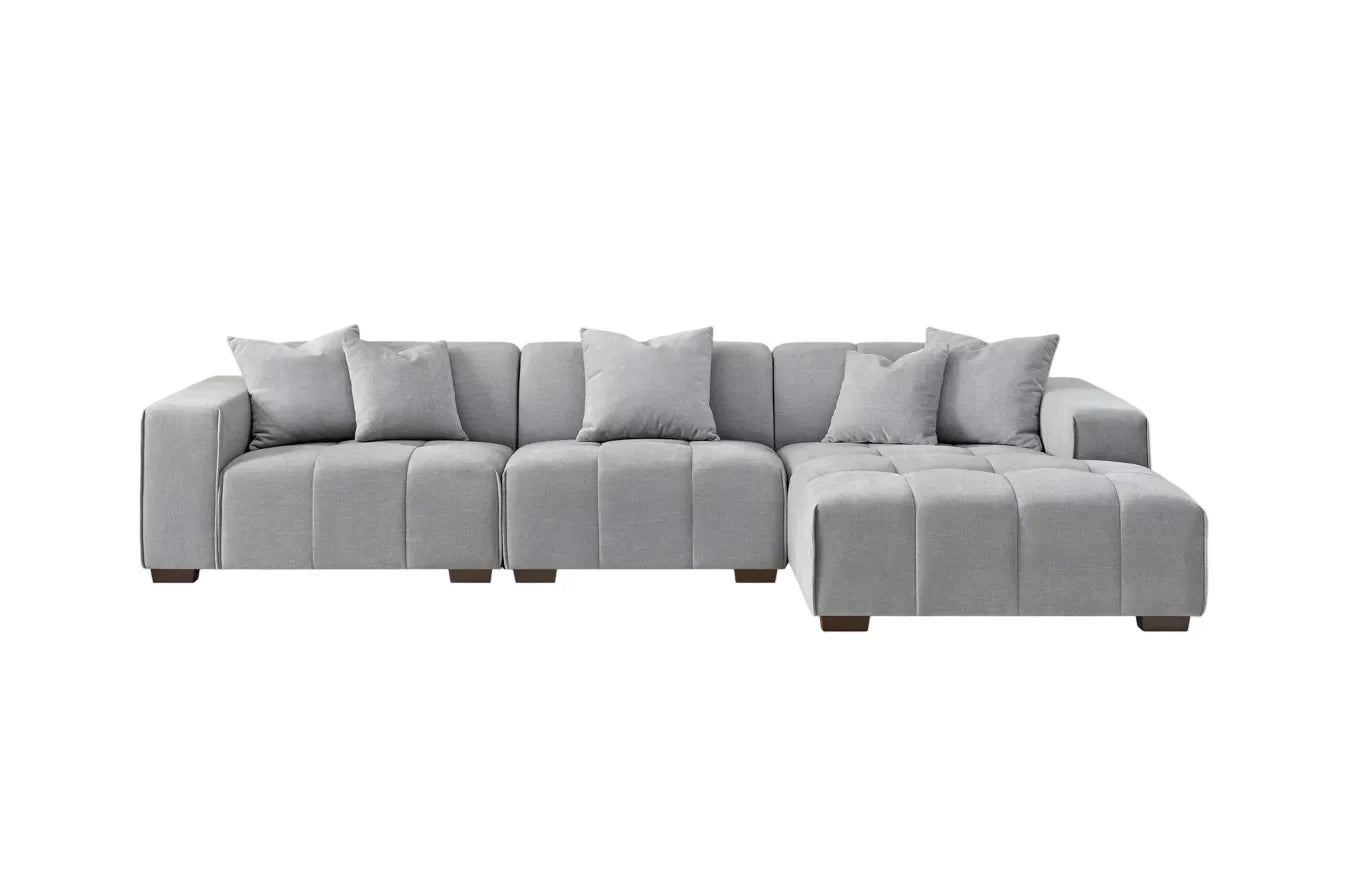 Luxury cloudy grey bouclé right-hand corner sofa with modular L-shaped design, block-stitched cushions, and five matching scatter cushions.