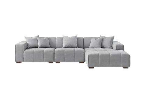 Luxury cloudy grey bouclé right-hand corner sofa with modular L-shaped design, block-stitched cushions, and five matching scatter cushions.