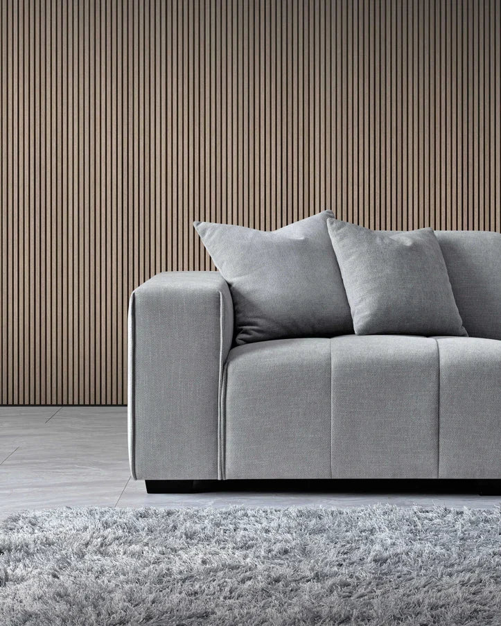 Luxury cloudy grey bouclé right-hand corner sofa with modular L-shaped design, block-stitched cushions.