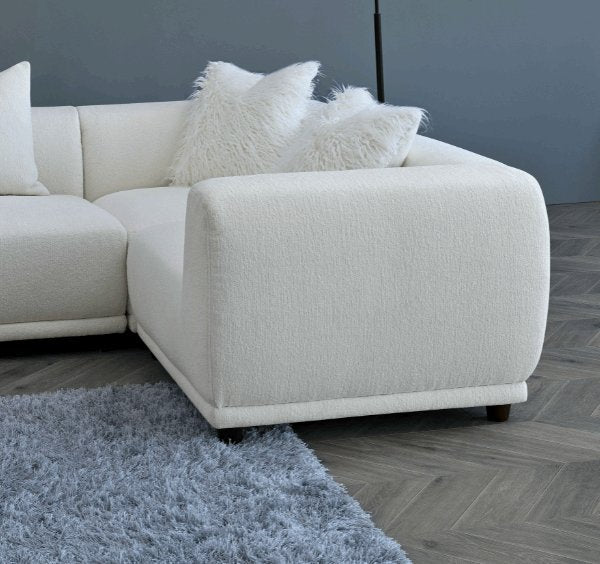 Luxury Lottie modular corner sofa upholstered in premium polar bouclé fabric featuring deep seating, soft curved lines.