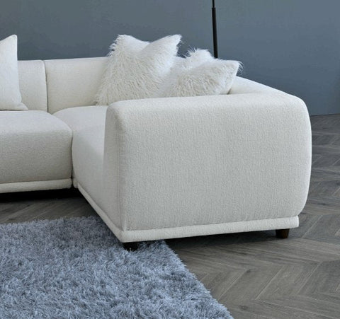 Luxury Lottie modular corner sofa upholstered in premium polar bouclé fabric featuring deep seating, soft curved lines.