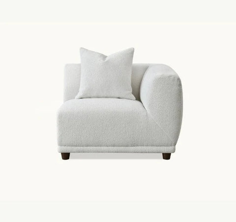 Luxury Lottie modular corner sofa upholstered in premium polar bouclé fabric featuring deep seating, soft curved lines, modular configuration for modern UK living rooms.