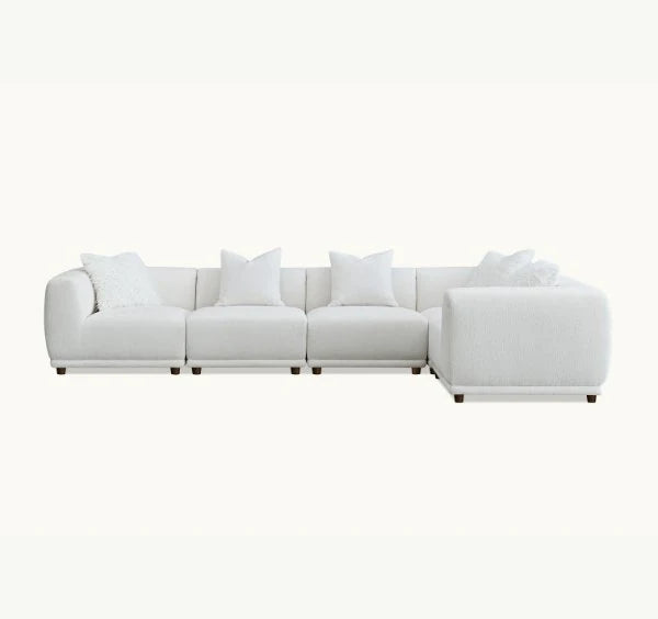 Corner sofa upholstered in premium polar bouclé fabric featuring deep seating, soft curved lines, modular configuration, and contemporary styling for modern UK living rooms.