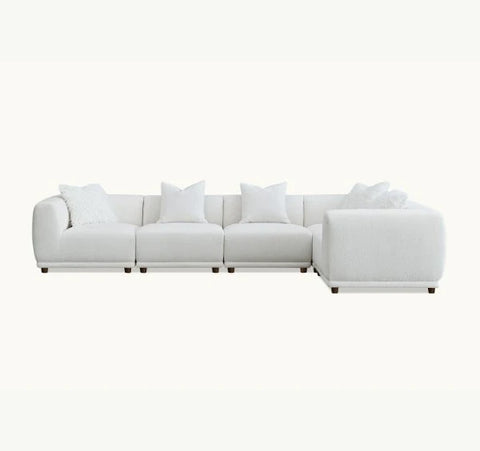 Corner sofa upholstered in premium polar bouclé fabric featuring deep seating, soft curved lines, modular configuration, and contemporary styling for modern UK living rooms.