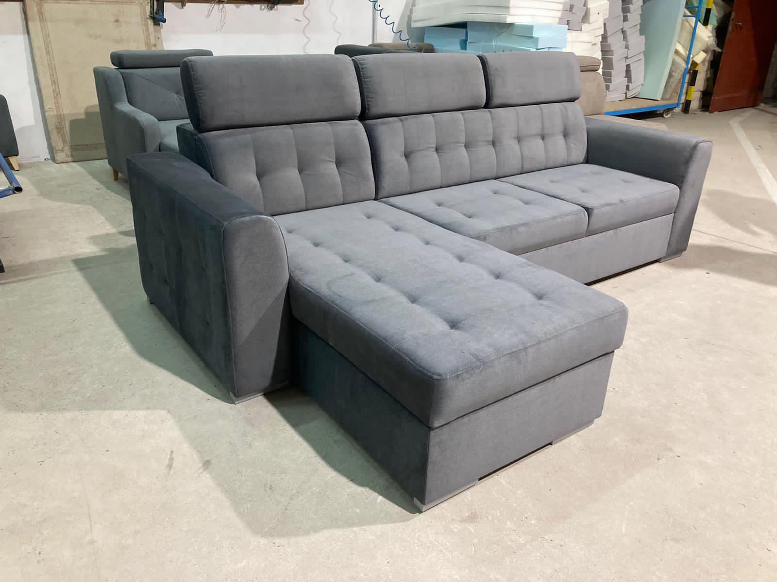 Luxury fabric corner sofa bed with hidden storage compartment, pull-out sleeping function, universal L-shaped design, and modern styling for contemporary UK homes.
