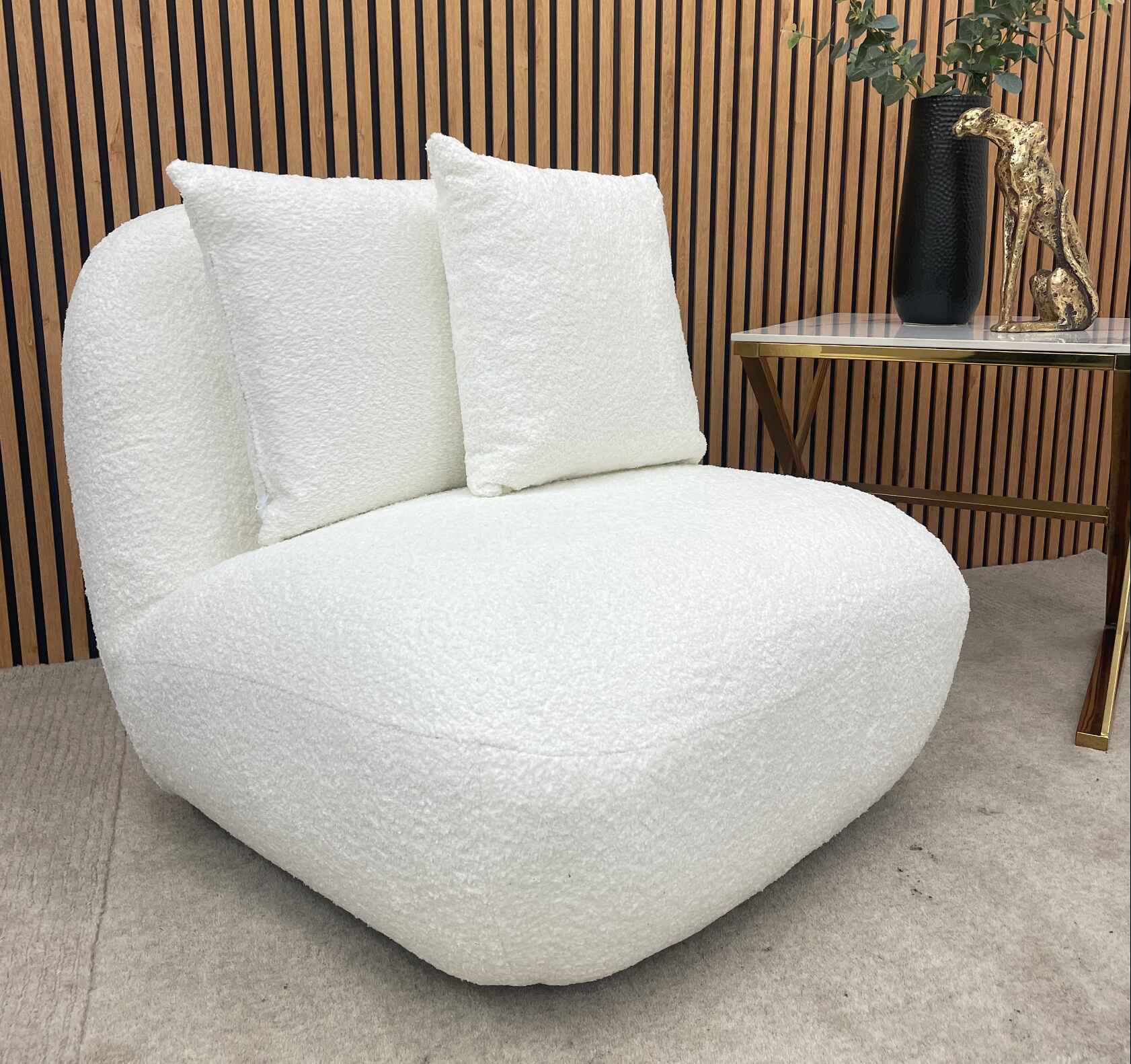 Contemporary bouclé armchair with two scatter cushions for modern UK homes.