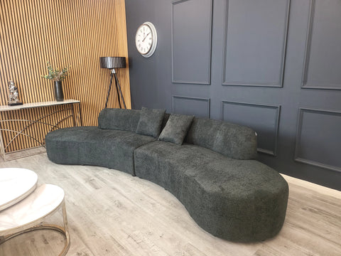 Miami curved 6-seater bouclé sofa with sculptural organic silhouette, deep cushioned seating, and premium textured upholstery in a contemporary UK living room.