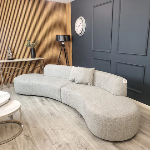 Luxury Miami curved 6-seater bouclé sofa with sculptural organic silhouette, deep cushioned seating, and premium textured upholstery in a contemporary UK living room.