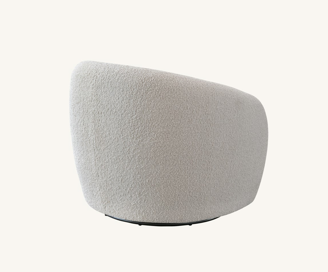 Luxury bouclé accent chair with soft textured fabric for elegant home interiors.