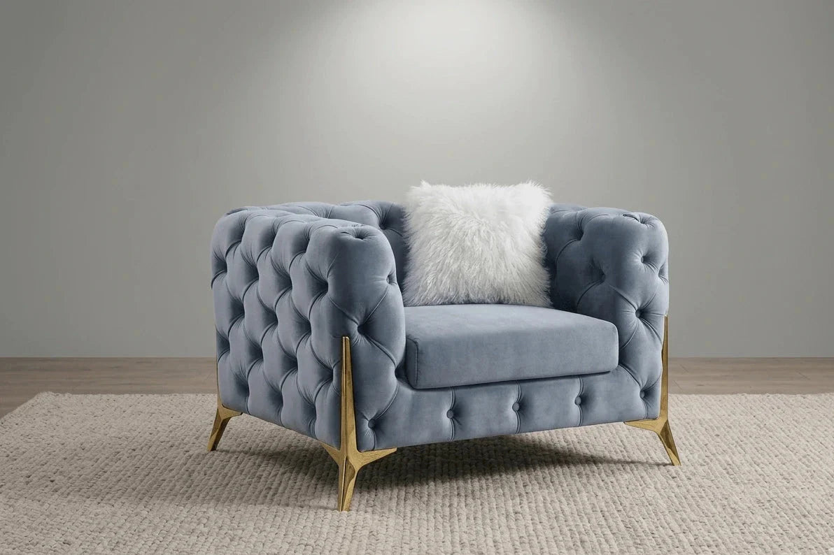 Luxury grey fabric sofa featuring classic Chesterfield button detailing.