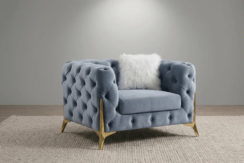 Luxury grey fabric sofa featuring classic Chesterfield button detailing.
