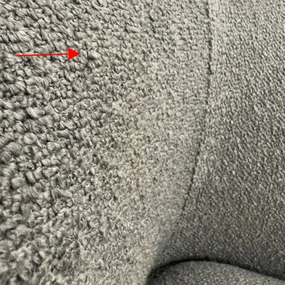 Luxury Pebble Bouclé Sofa with a sculptural curved design, soft textured bouclé upholstery, deep cushions.
