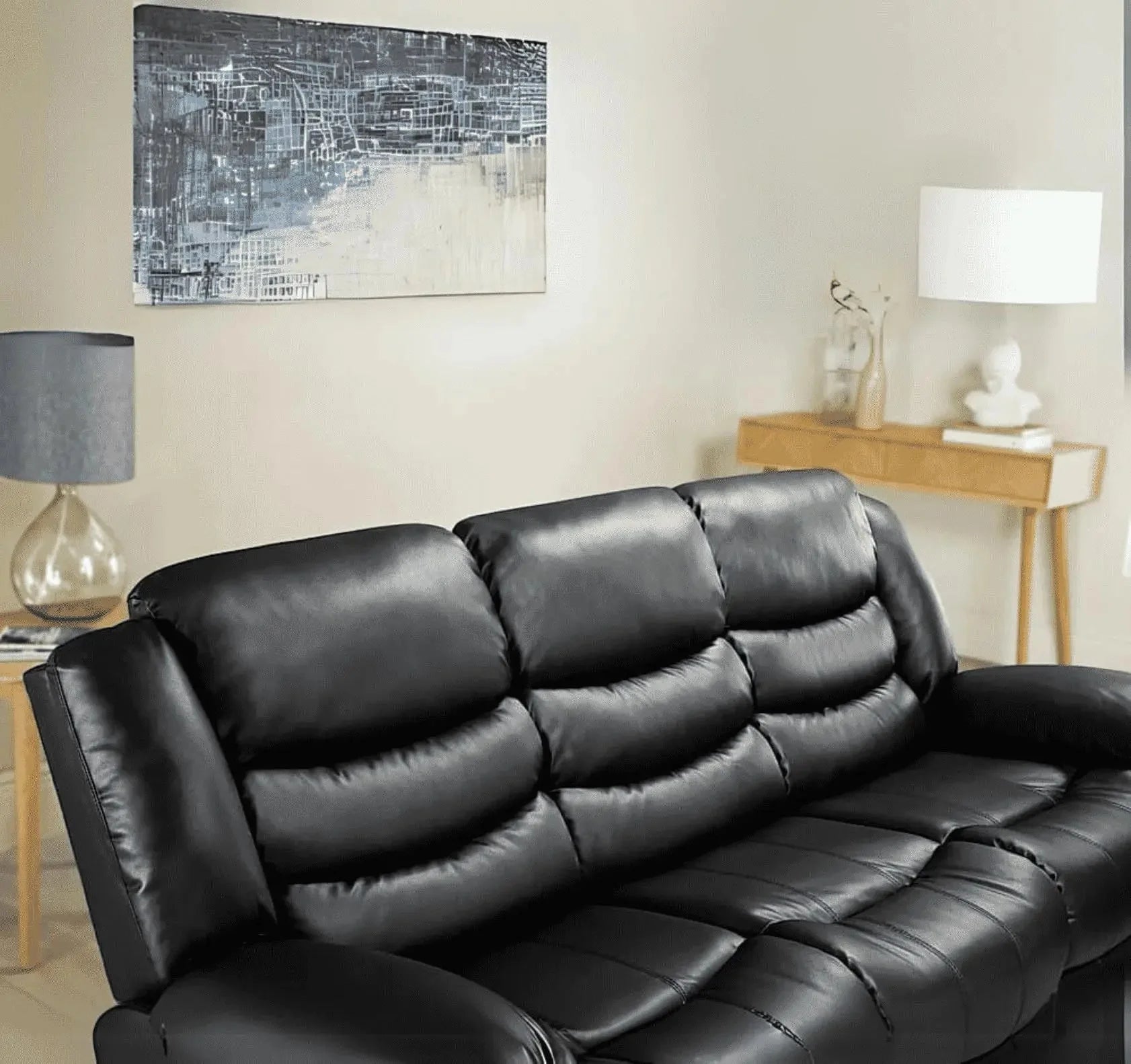 Contemporary black 3 seater recliner sofa with plush comfortable cushions.