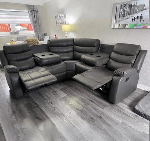 Modern light grey leather recliner corner sofa with comfortable reclining seats and cupholders.