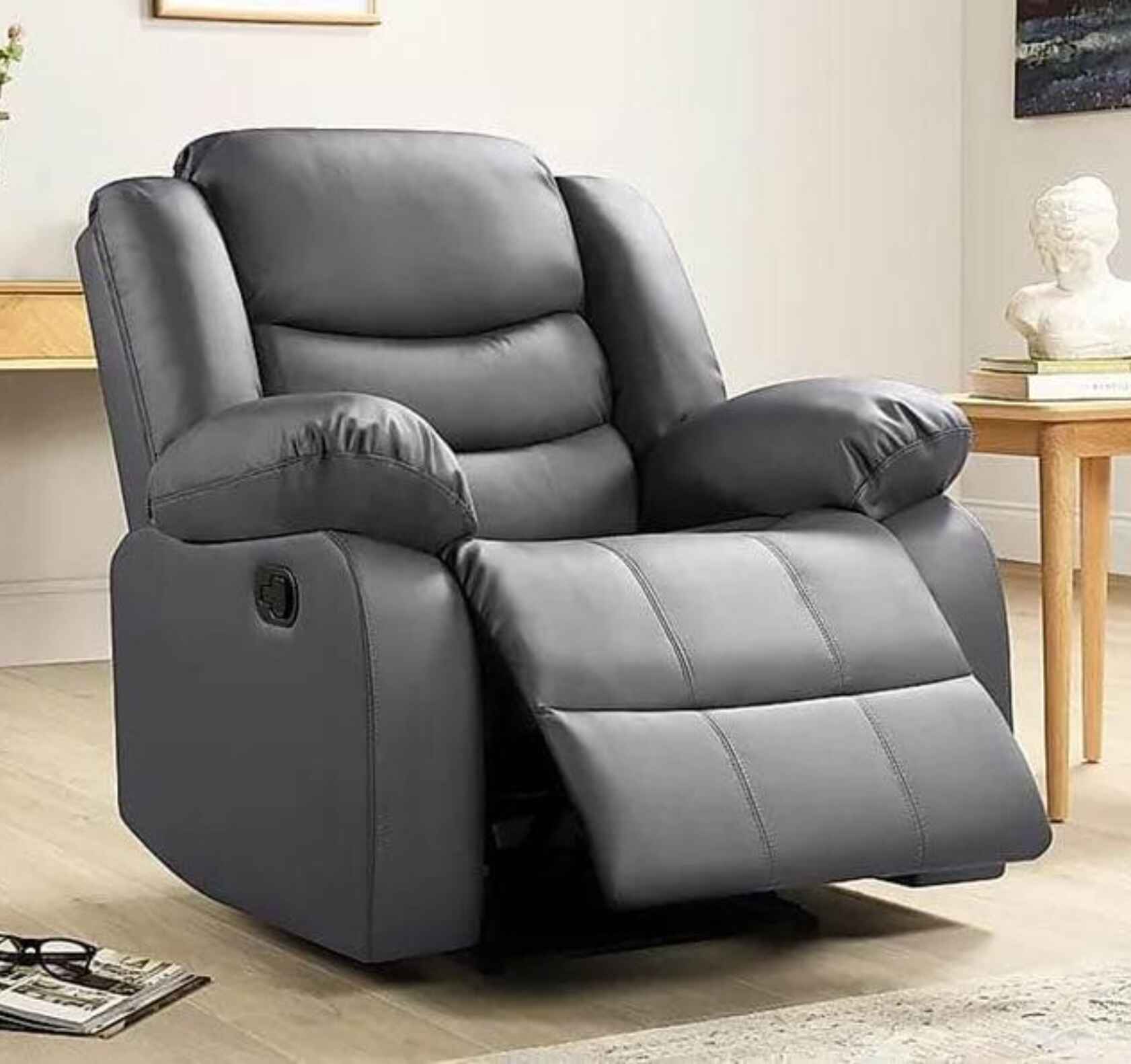 Contemporary leather recliner armchair available in black and grey finishes.